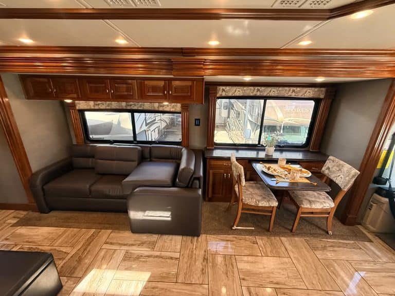Interior of a 2018 Fleetwood Discovery RV with sofa and dining area.