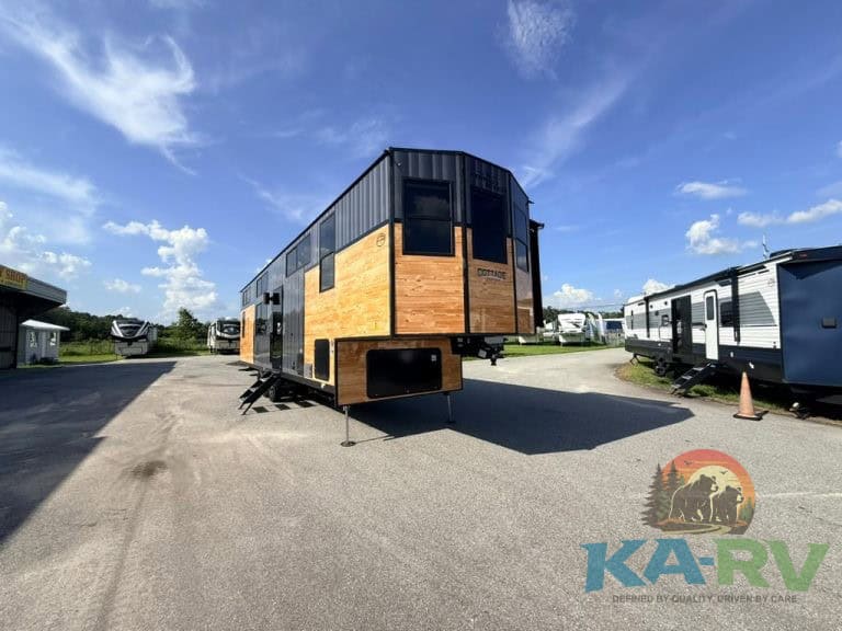 Modern Cedar Creek Cottage 41 FWC RV with black and wood exterior.