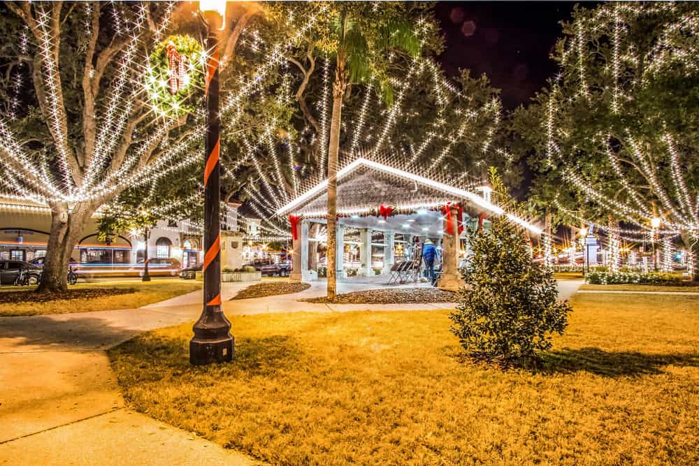 Brightly lit RV park decorated for Christmas with string lights and holiday ornaments.