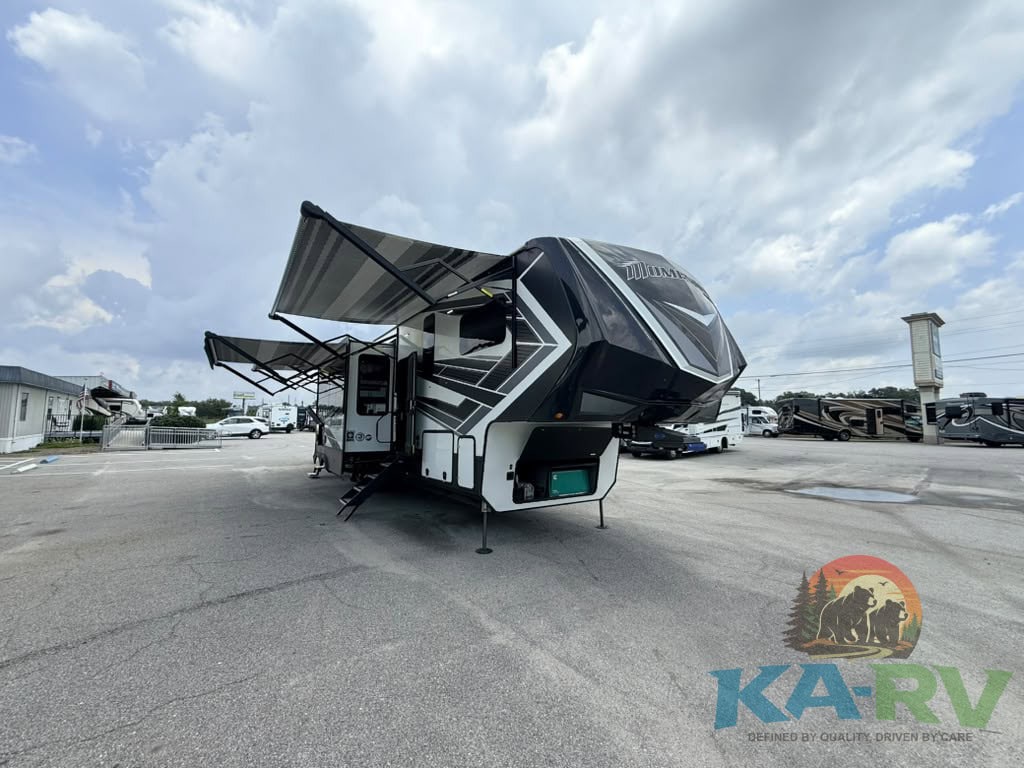 Luxury 2022 Grand Design Momentum 397th RV with extended awning and outdoor setup.