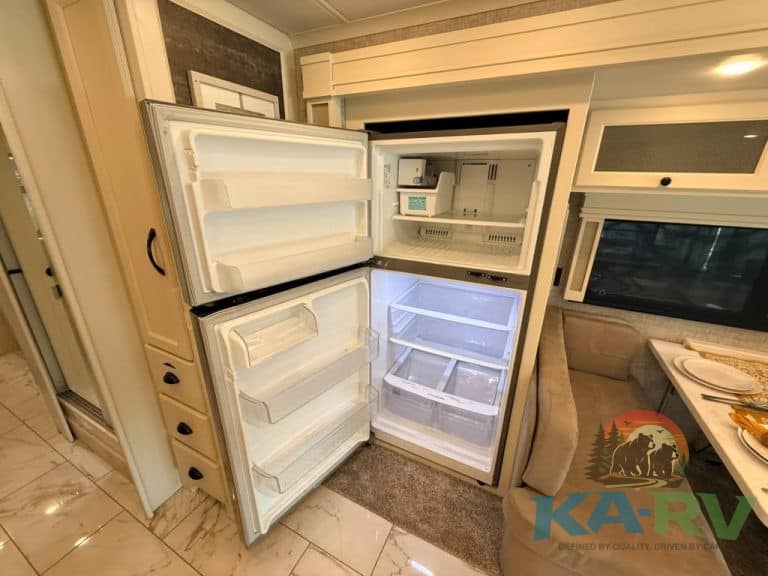 Open refrigerator in Tiffin Allegro Bay RV for repair or inspection.