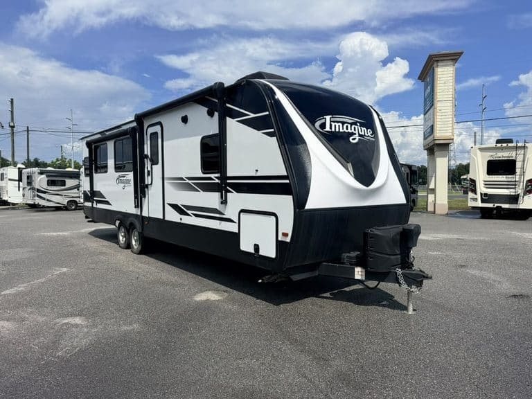 Modern Imagin RV travel trailer parked in dealership lot.