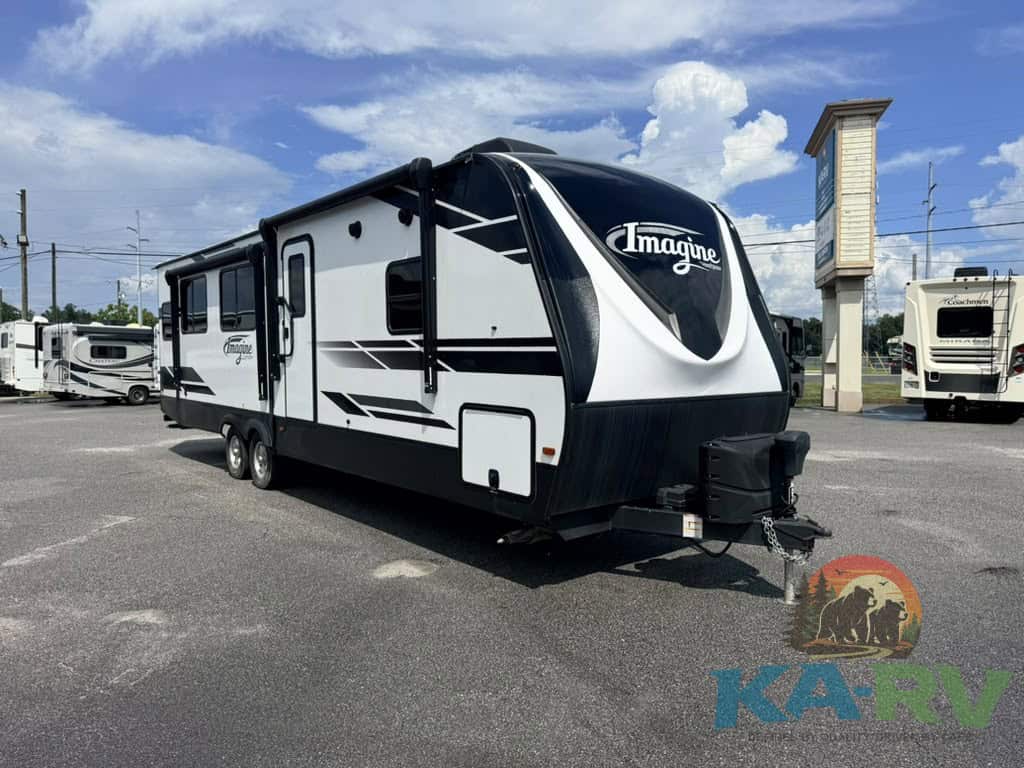 Modern Imagin RV travel trailer parked in dealership lot.
