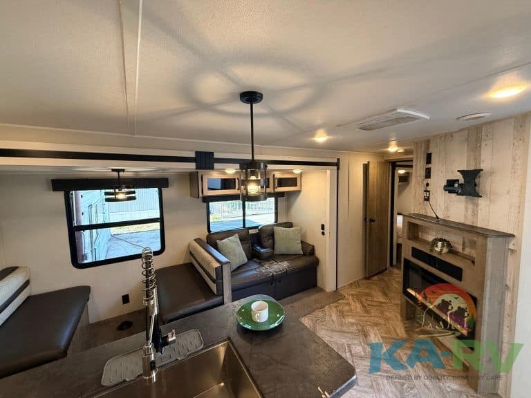 RV interior living space with modern decor and cozy seating area.