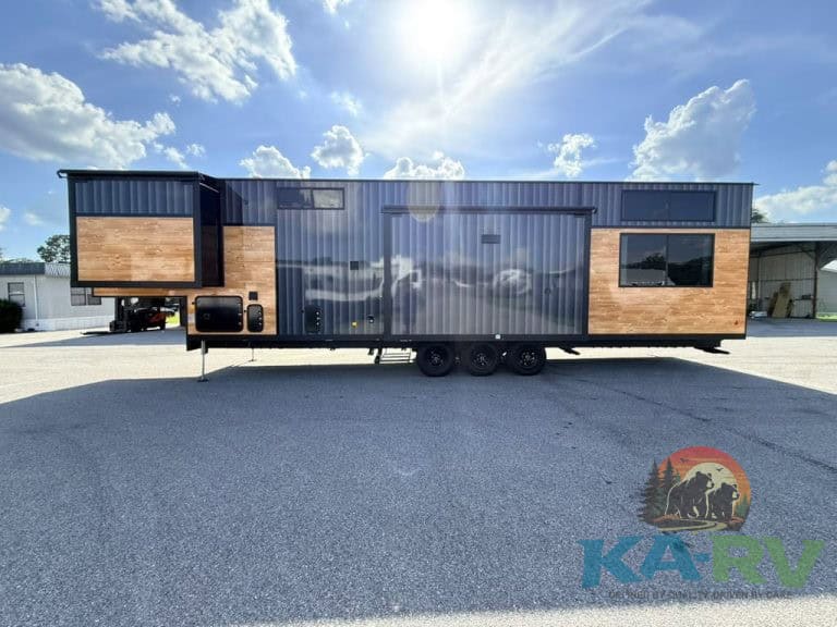 Contemporary Cedar Creek Cottage 41 FWC travel trailer with wood and metal exterior.