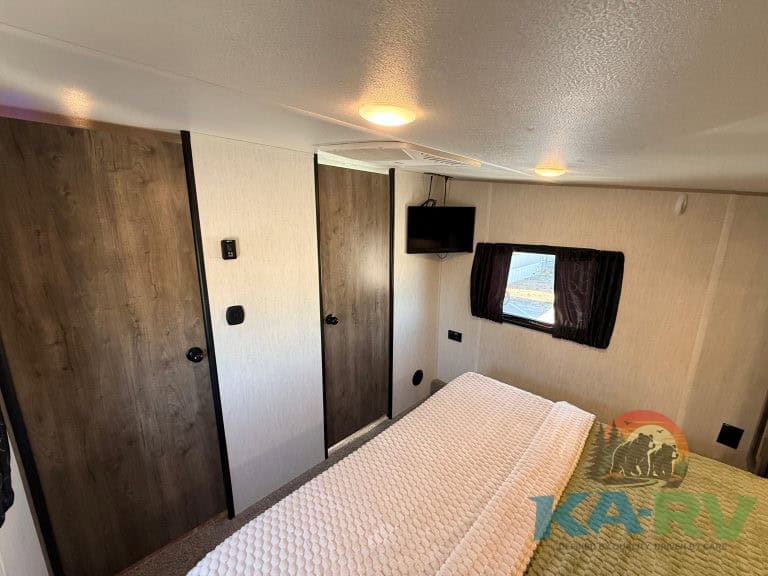 Interior of a 2021 Forest River Cherokee Wolf Pack 325PACK13 RV bedroom.
