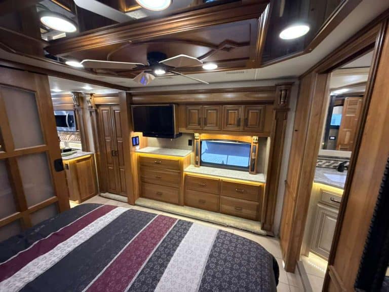 Luxury RV interior with wooden cabinets and modern amenities.