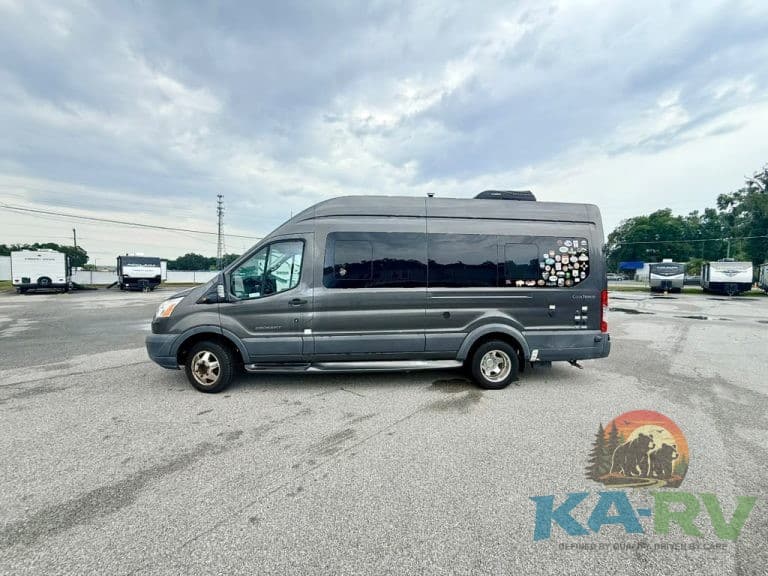Custom van at KA RV Repair service center in an outdoor lot.