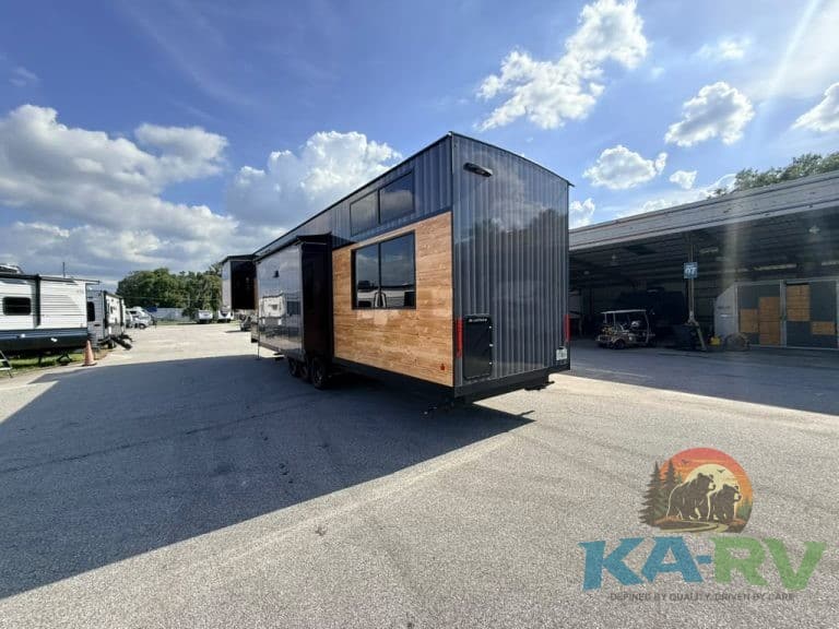 Contemporary black and wood RV parked at Karv Repair service center.