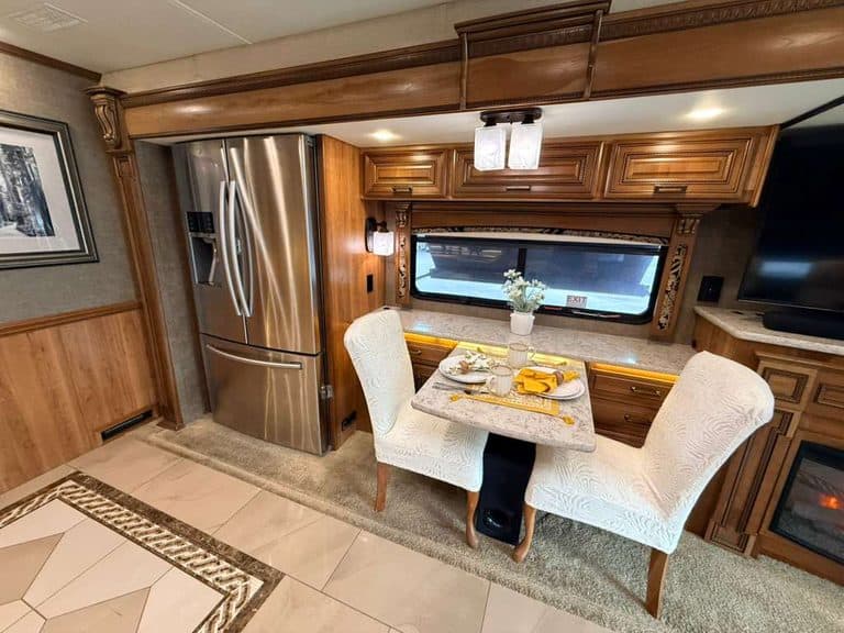 Luxury RV interior with dining area and kitchen in a 2016 Entegra Cornerstone 45B.