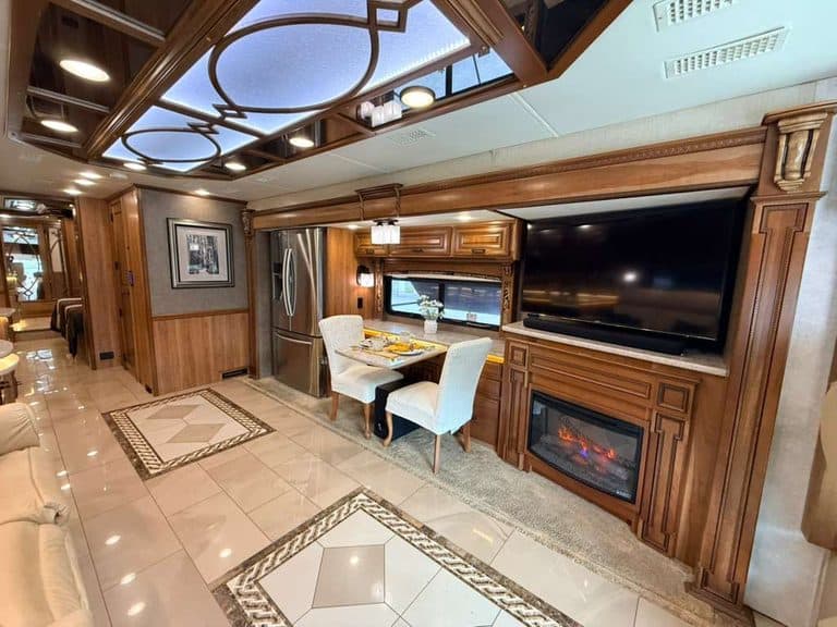 Luxury RV interior with dining area and fireplace in a 2016 Entegra Cornerstone 45B.