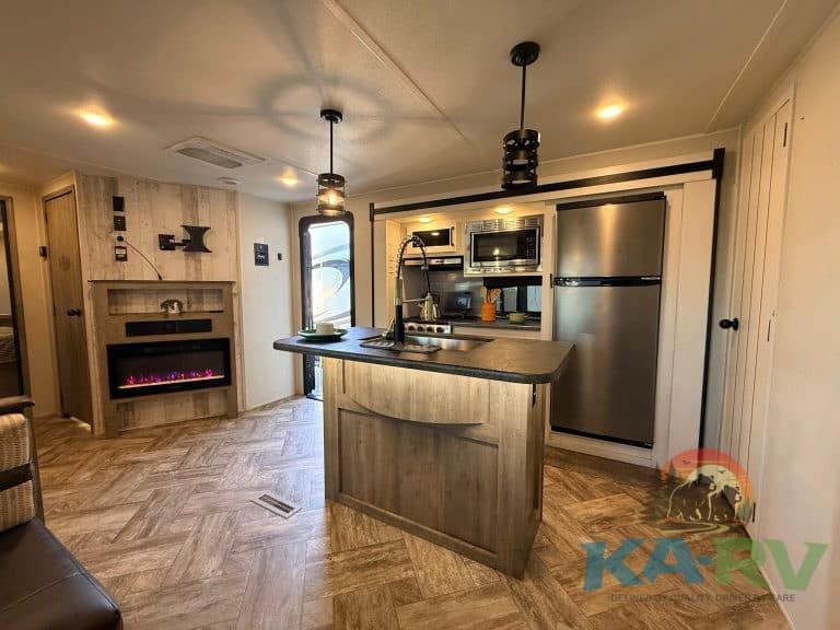 KA RV Repair interior shot of a well-equipped RV kitchen with appliances and cozy design.