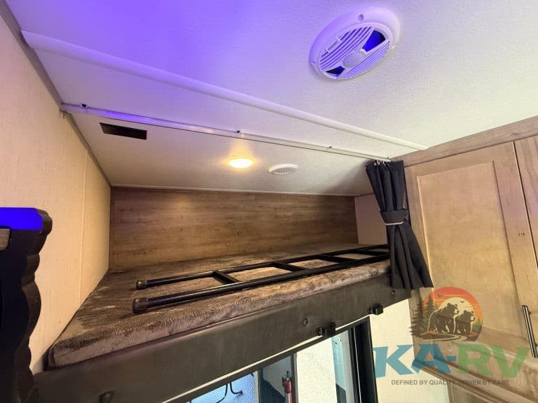 Overhead storage space in a 2021 Forest River Cherokee Wolf Pack 325PACK13 RV.