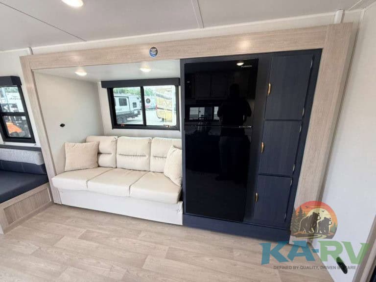 Interior of 2026 Acclaim 2500RD RV with sofa and storage cabinets.