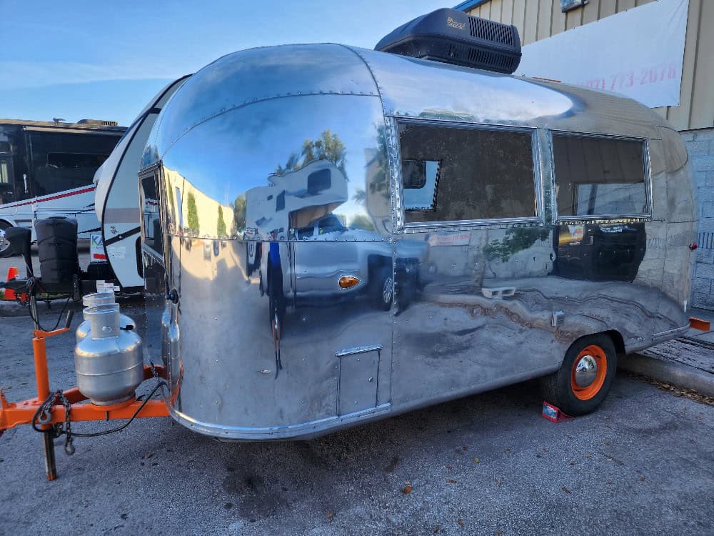 Airstream Bambi before and after body restoration in Orlando. Expert repair services for vintage tra.