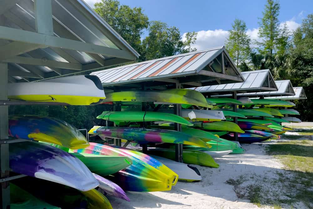 Outdoor boat storage racks with colorful kayaks and canoes in Orlando.