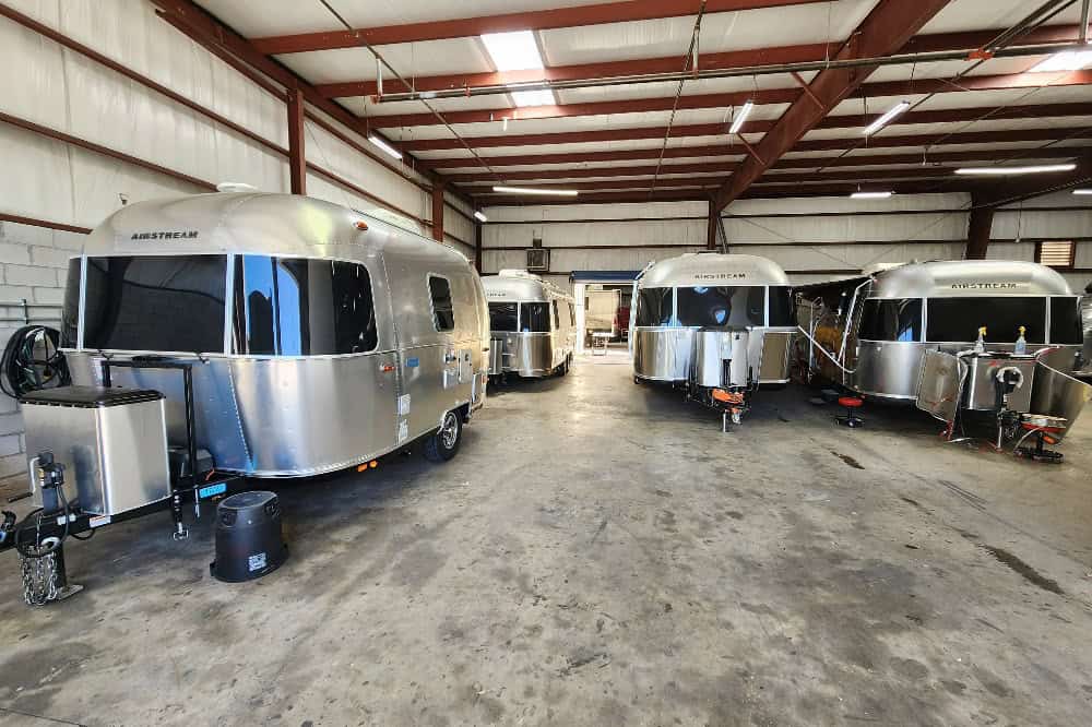 Modern RVs inside a repair shop ready for inspection and maintenance.