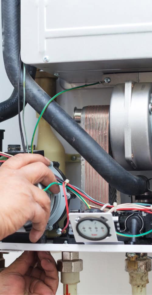 working doing maintenance on heating boiler
