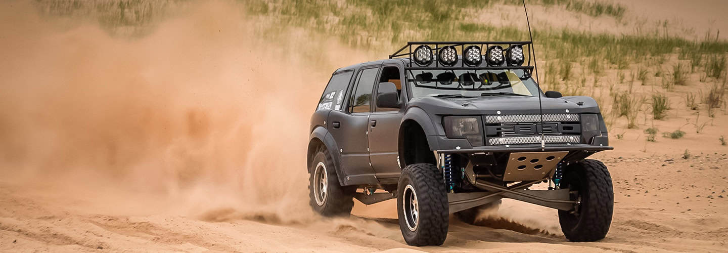Ford prerunner racing on sand track
