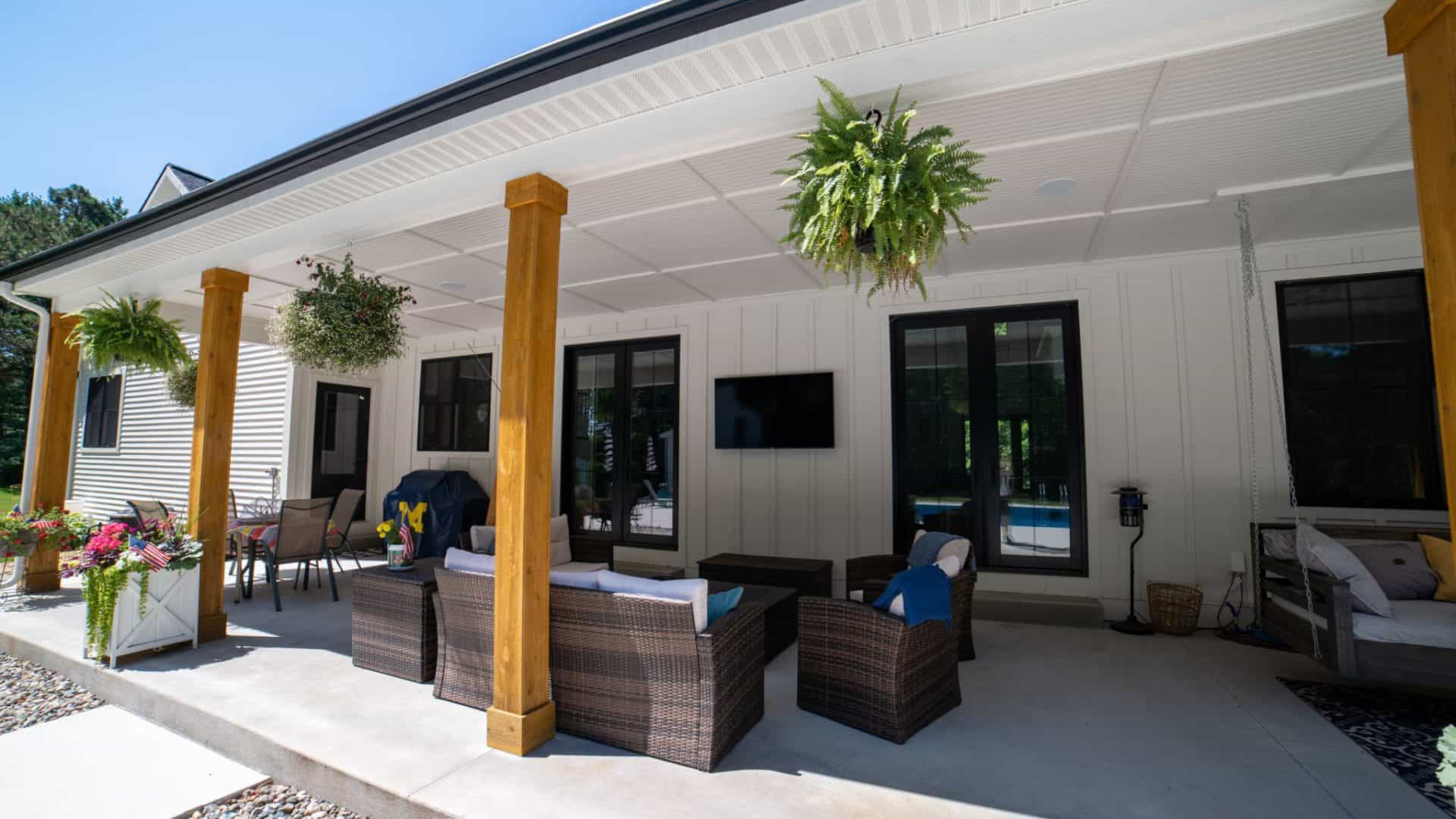Spacious outdoor patio of Livingston Homes with seating and hanging plants.