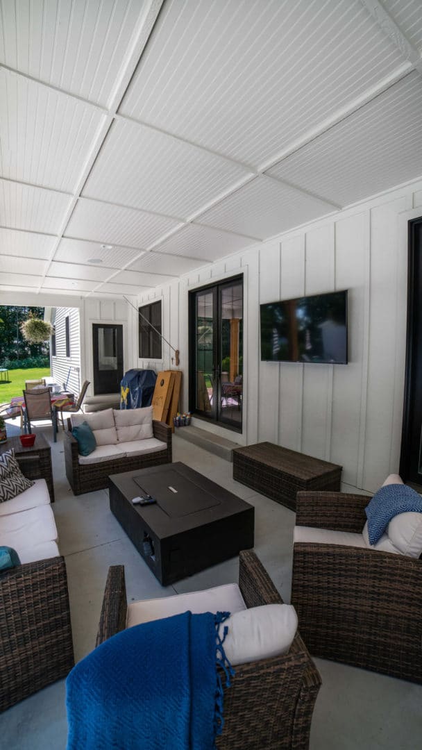Bright and spacious sunroom with comfortable seating and modern decor. Perfect for relaxing and enjo.