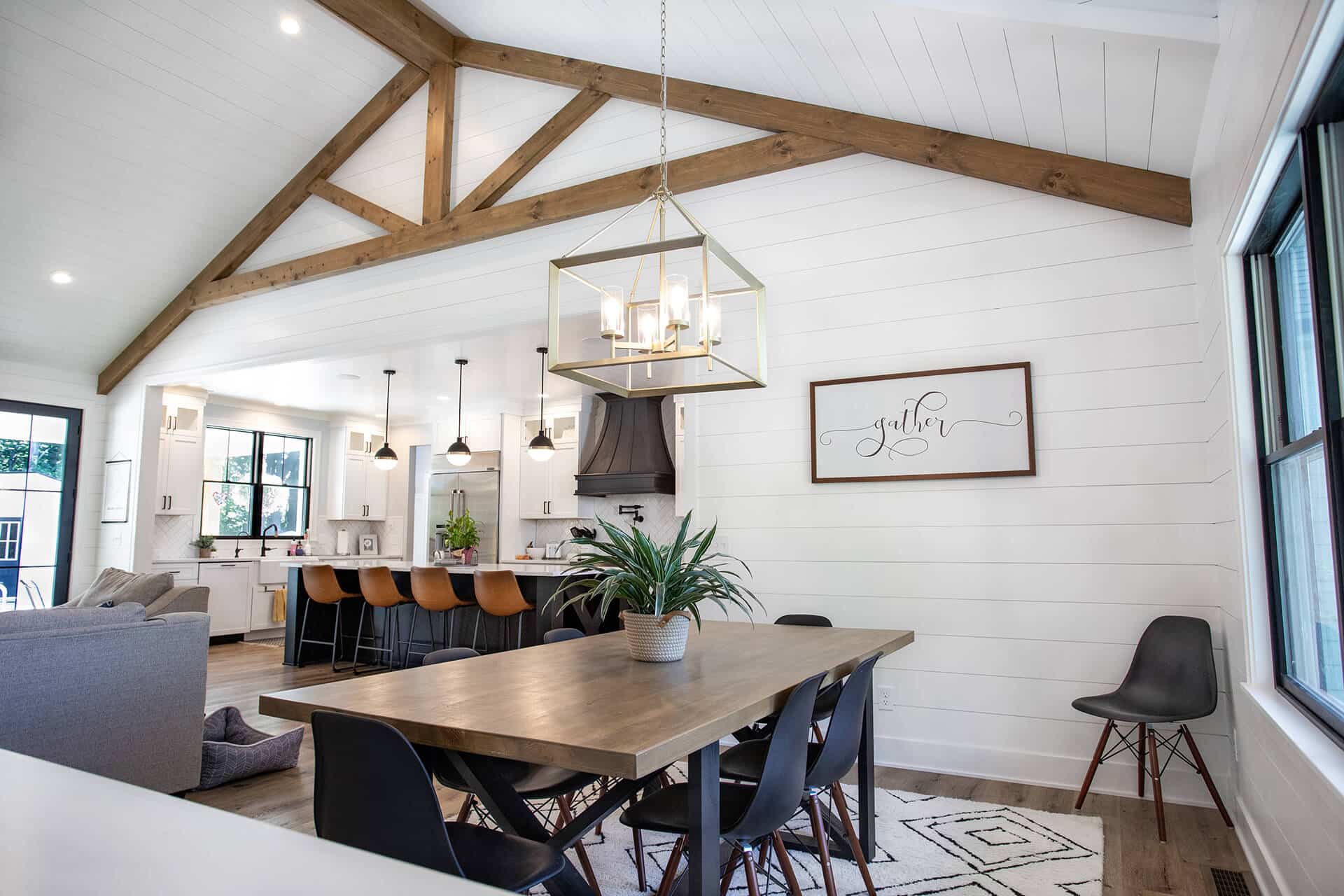 Modern open-concept living and dining area with vaulted ceilings.
