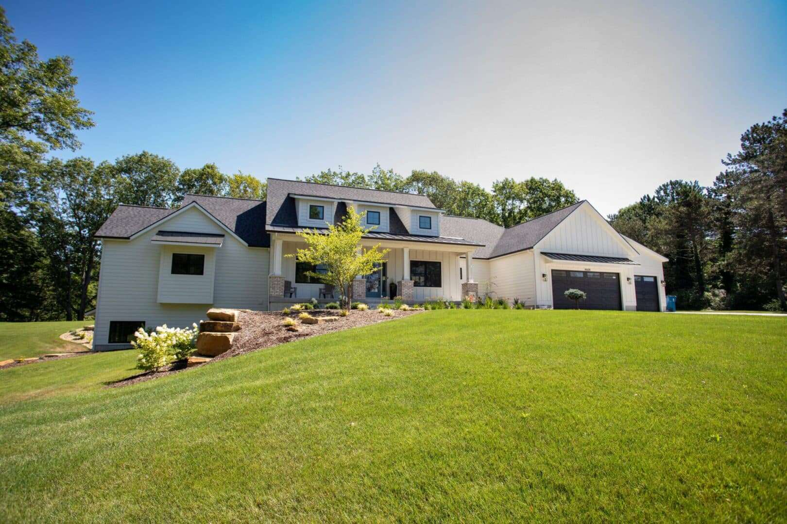 Beautiful modern house with spacious yard and lush greenery.