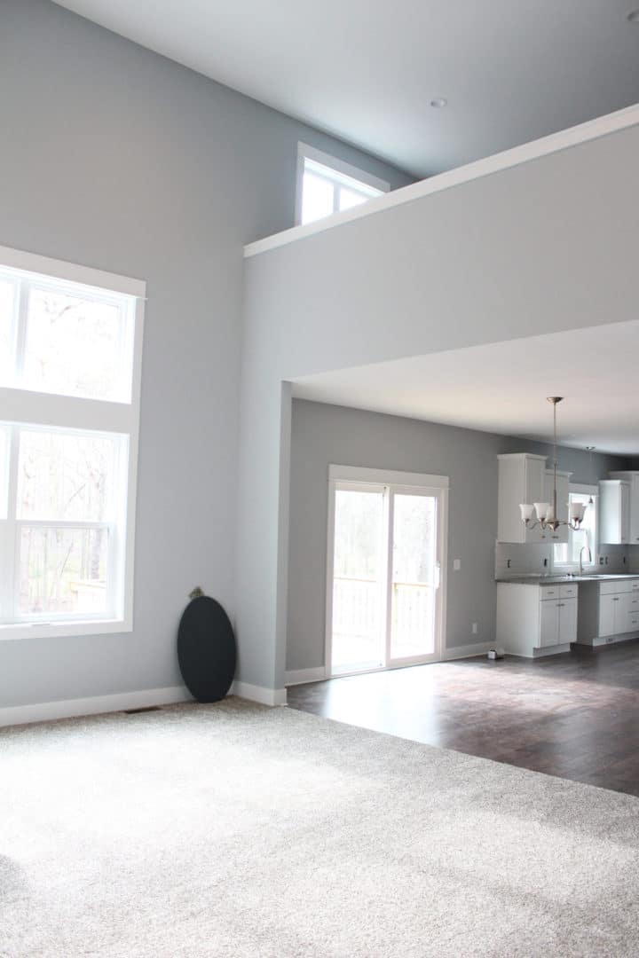 Bright and spacious living room with large windows and high ceilings.