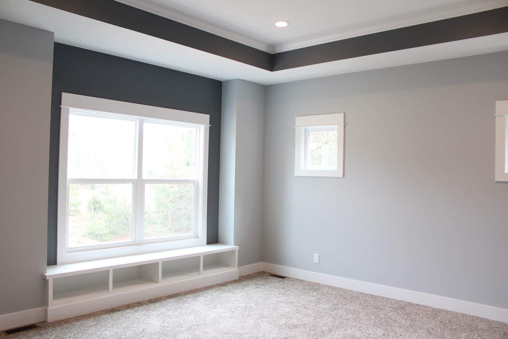 Bright living room with large windows and modern design.