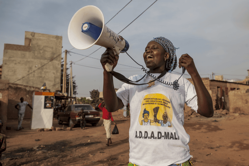 Woman from Mali talking into a megaphone.