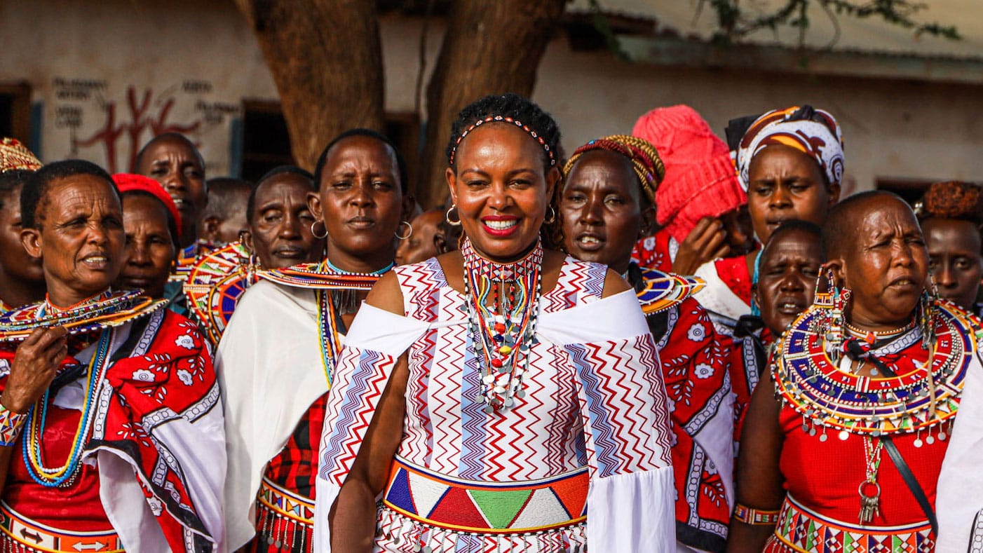 Masaai women reading materials at workshop organised by Patinaai Osima group of Masaai women look at the camera