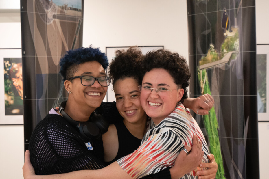 image of three women activists hugging and smiling
