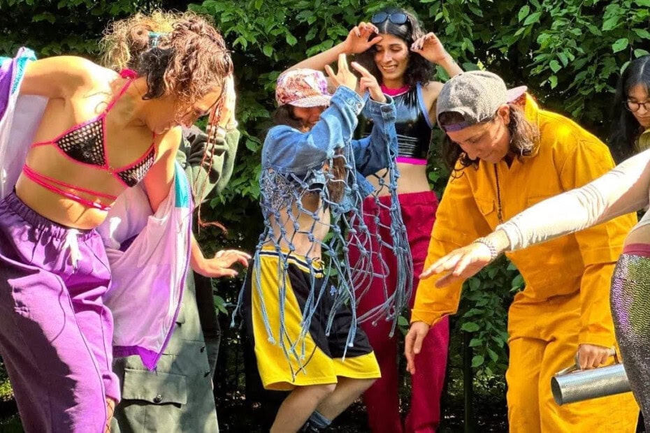 group of people with colourful clothes dancing outdoors
