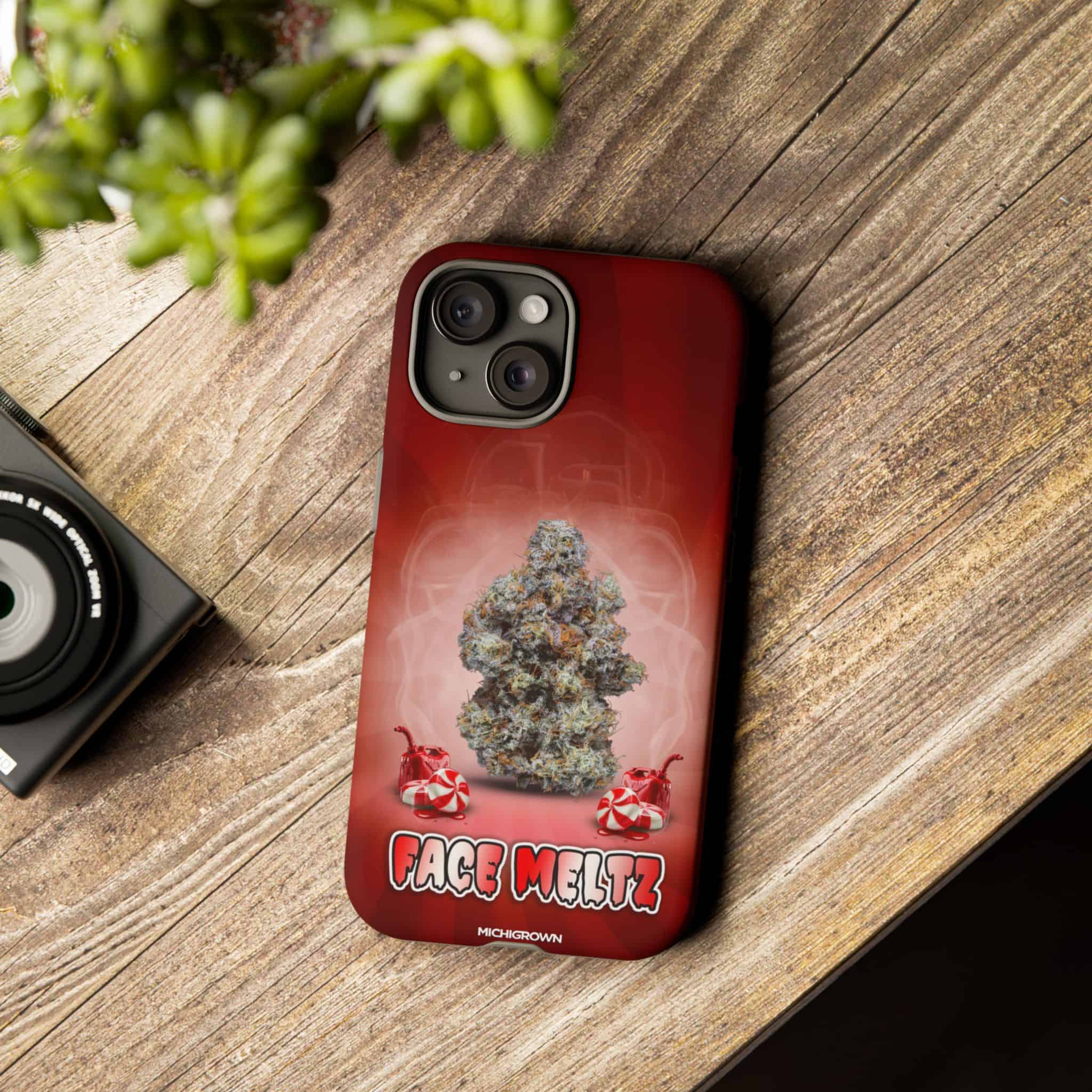 Red phone case with cannabis bud and Face Meltz logo.