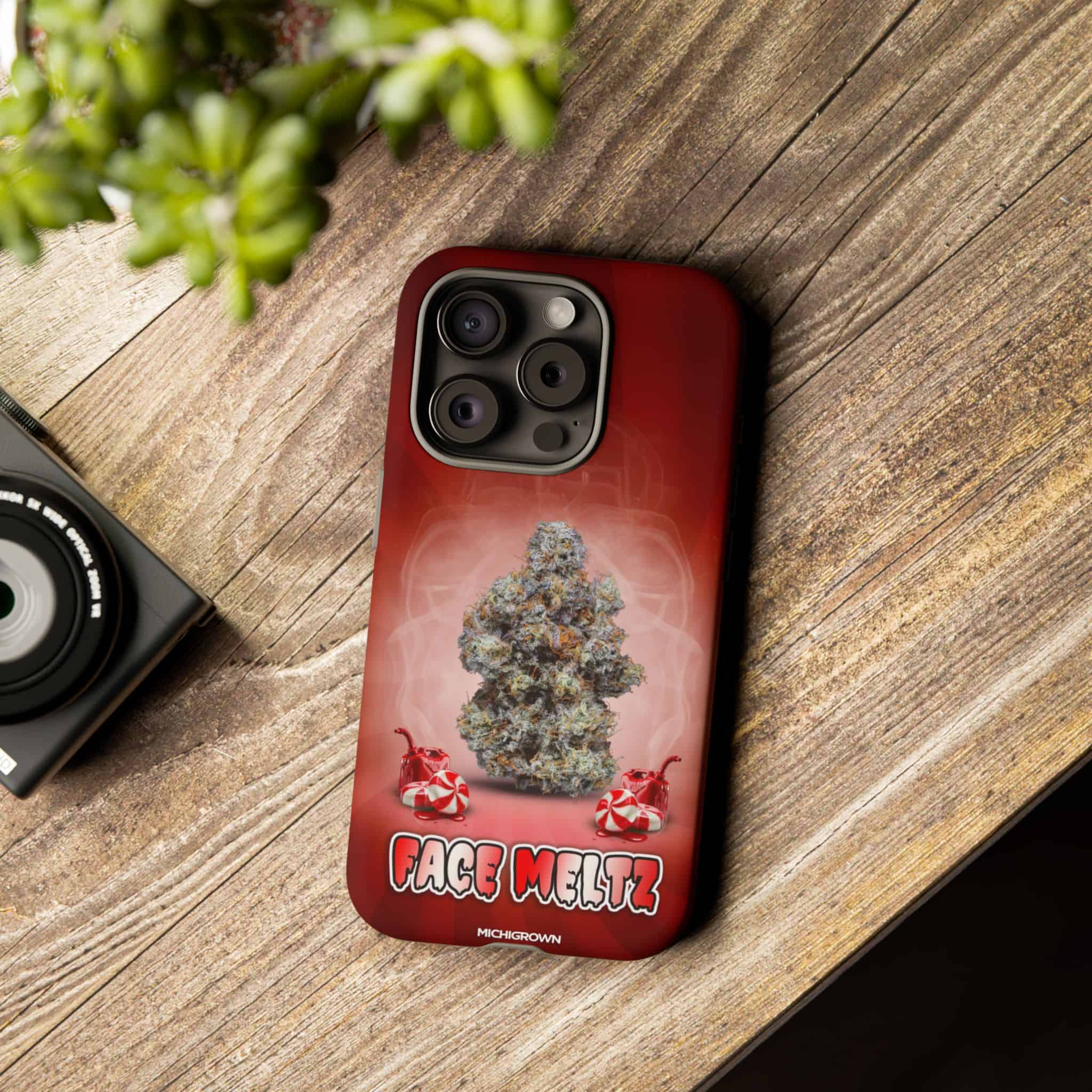Red phone case with cannabis bud graphic and Face Meltz logo.