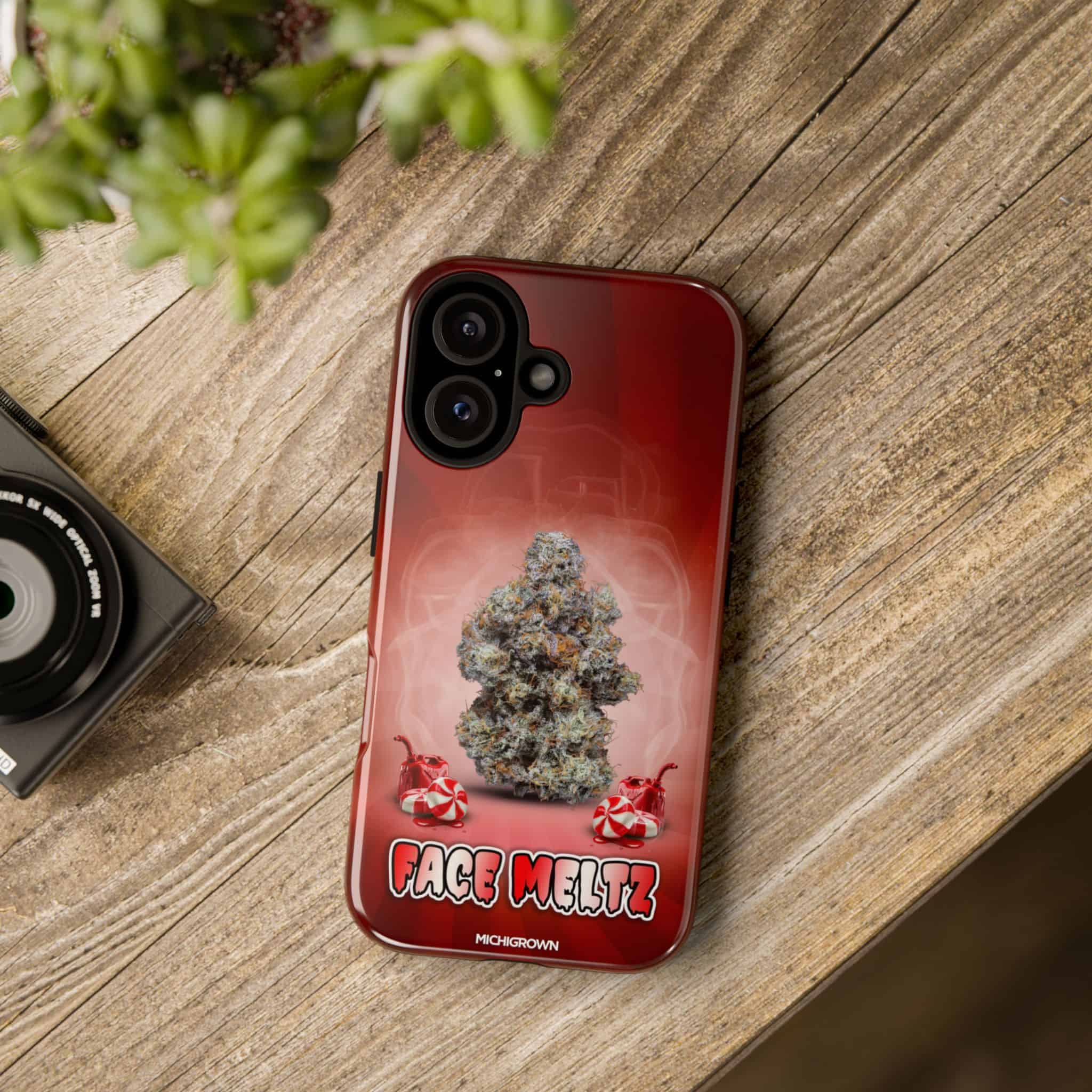 Red phone case with cannabis bud and Face Meltz logo.
