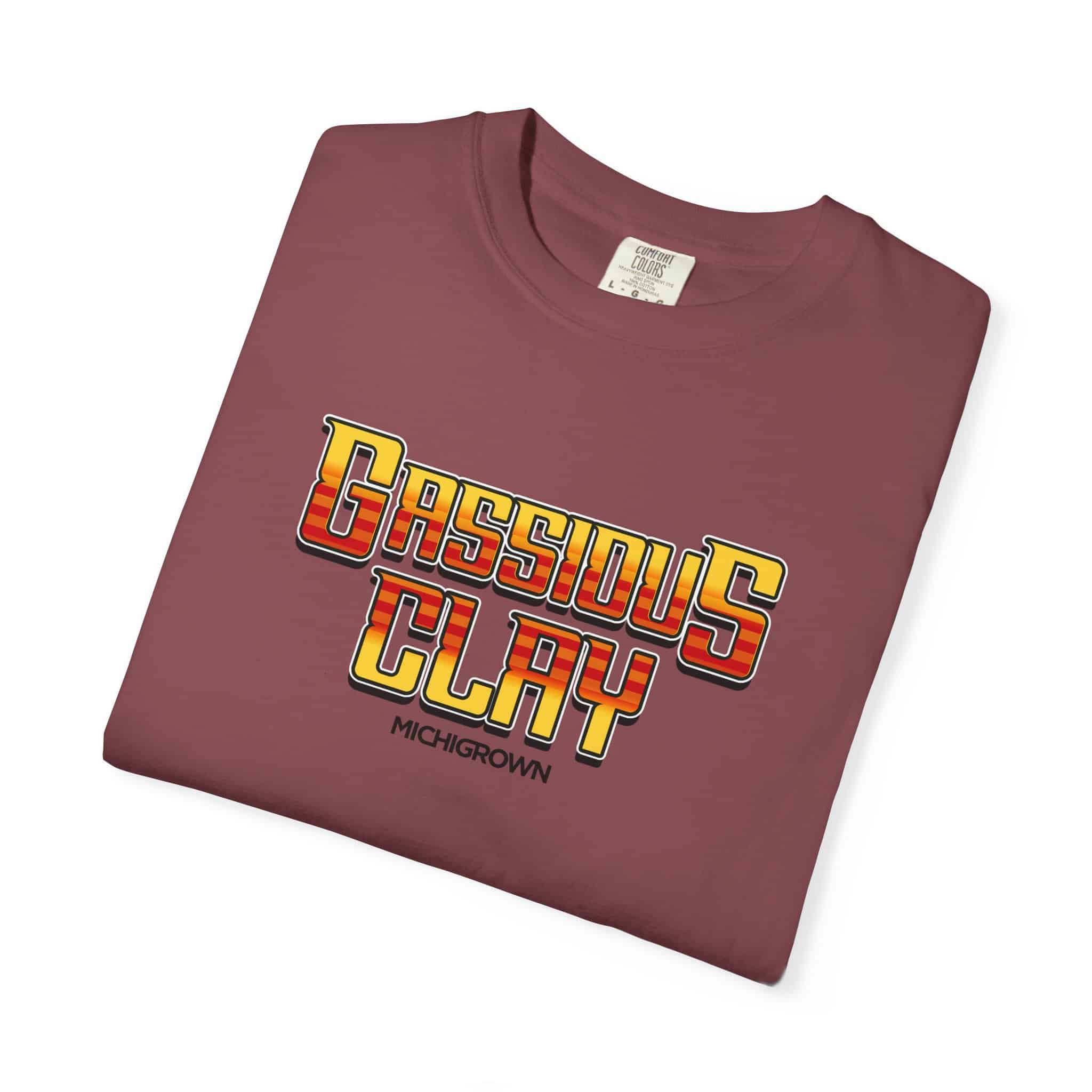 Maroon Gassious Clay T-shirt with bold yellow and red text.