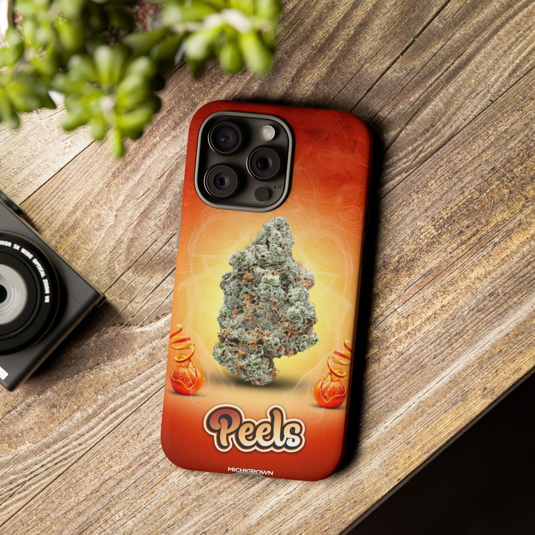 Phone case featuring cannabis bud and Peels logo on wooden surface.