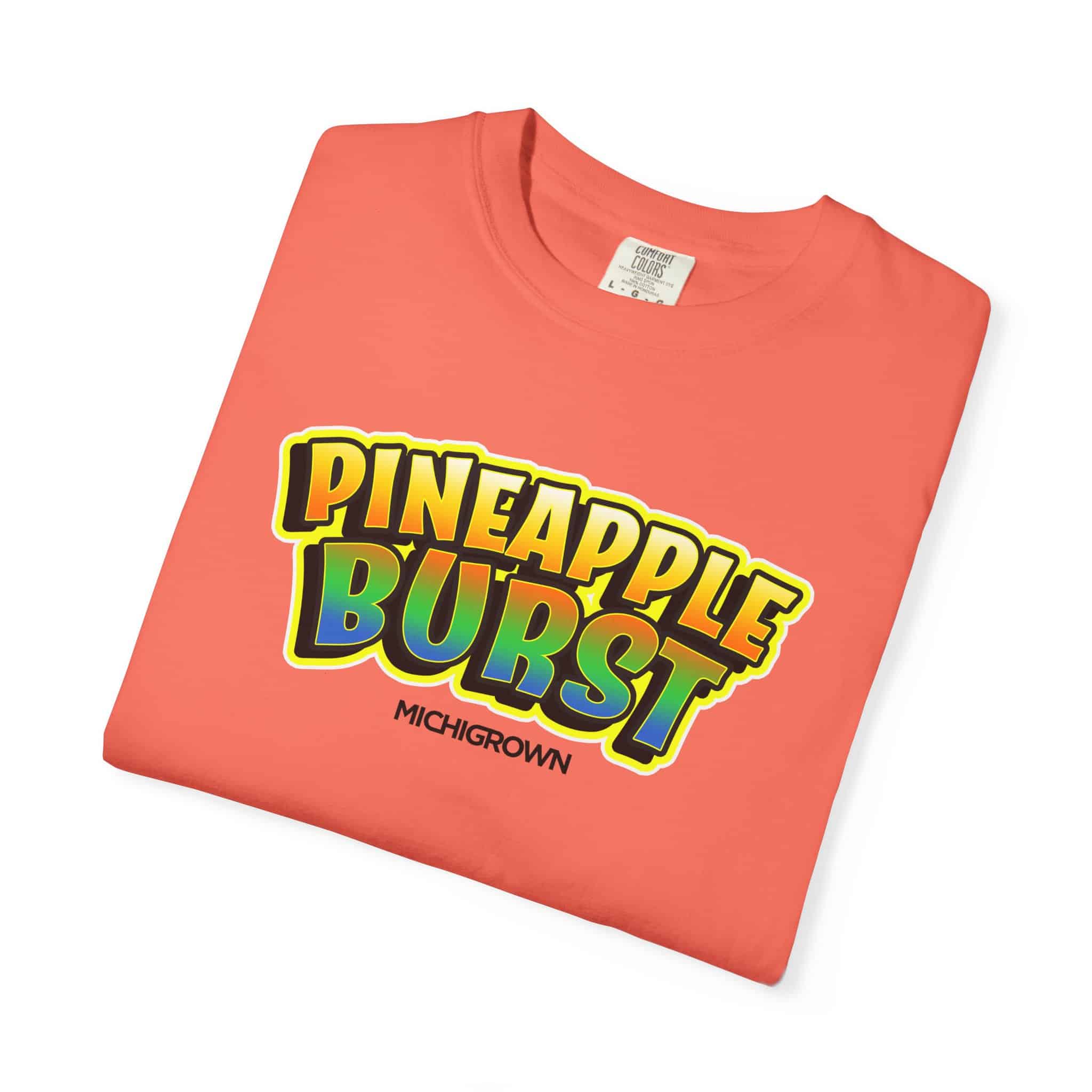 Coral pink Pineapple Burst T-shirt with colorful logo design.