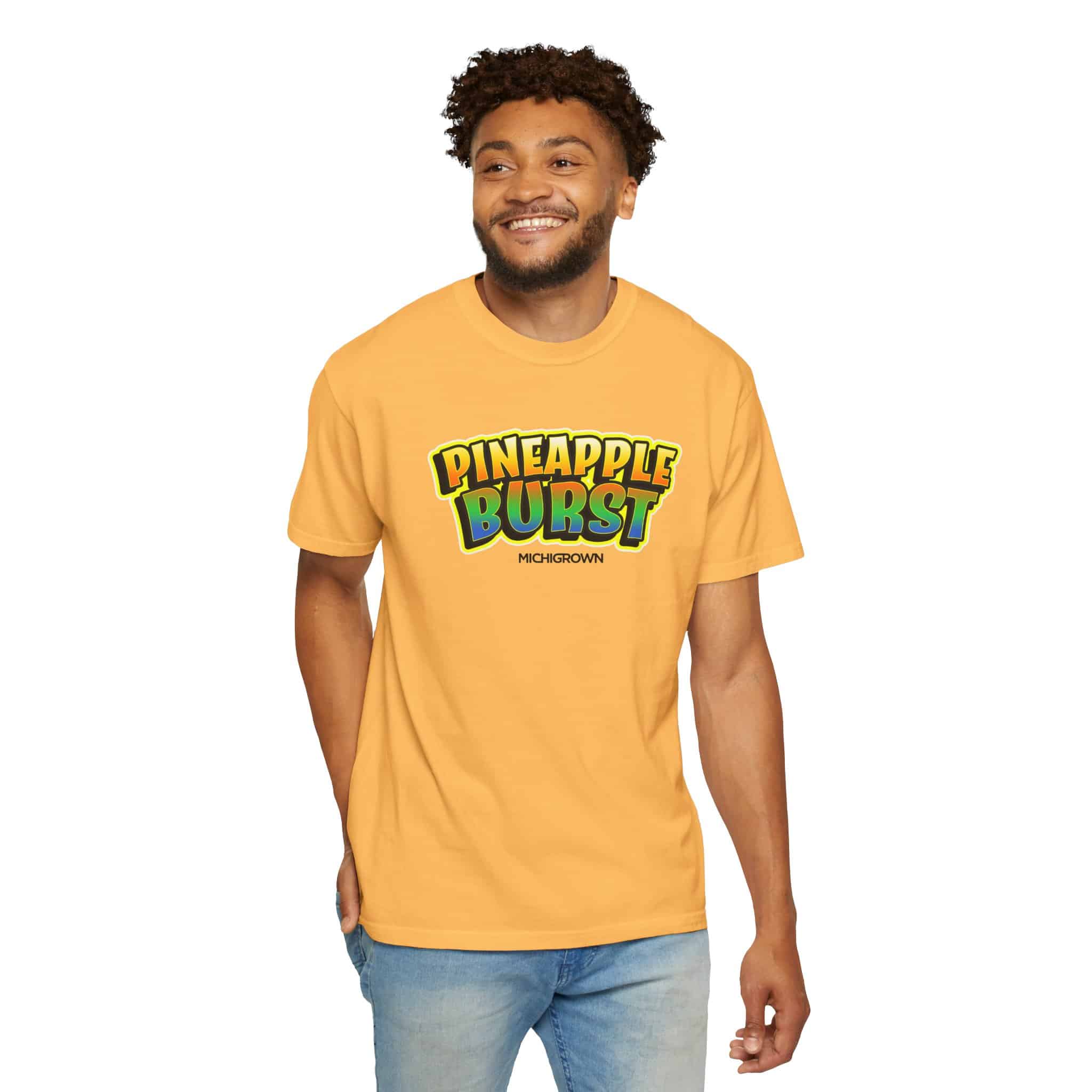 Man wearing yellow Pineapple Burst T-shirt with colorful logo.