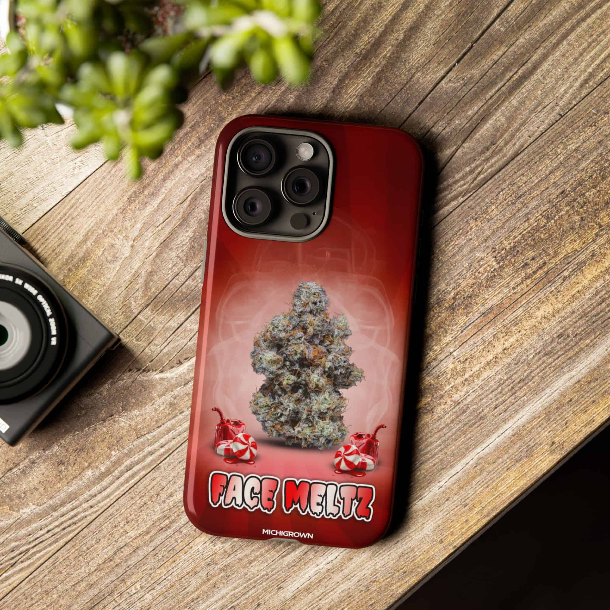Red phone case with cannabis bud and Face Meltz logo.