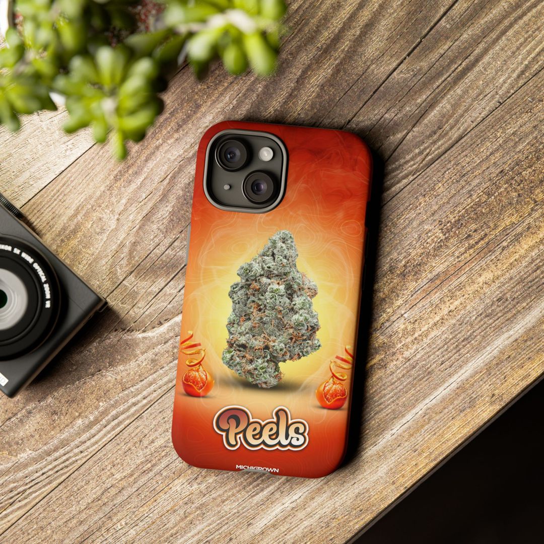 Phone case with cannabis bud design on wooden surface.