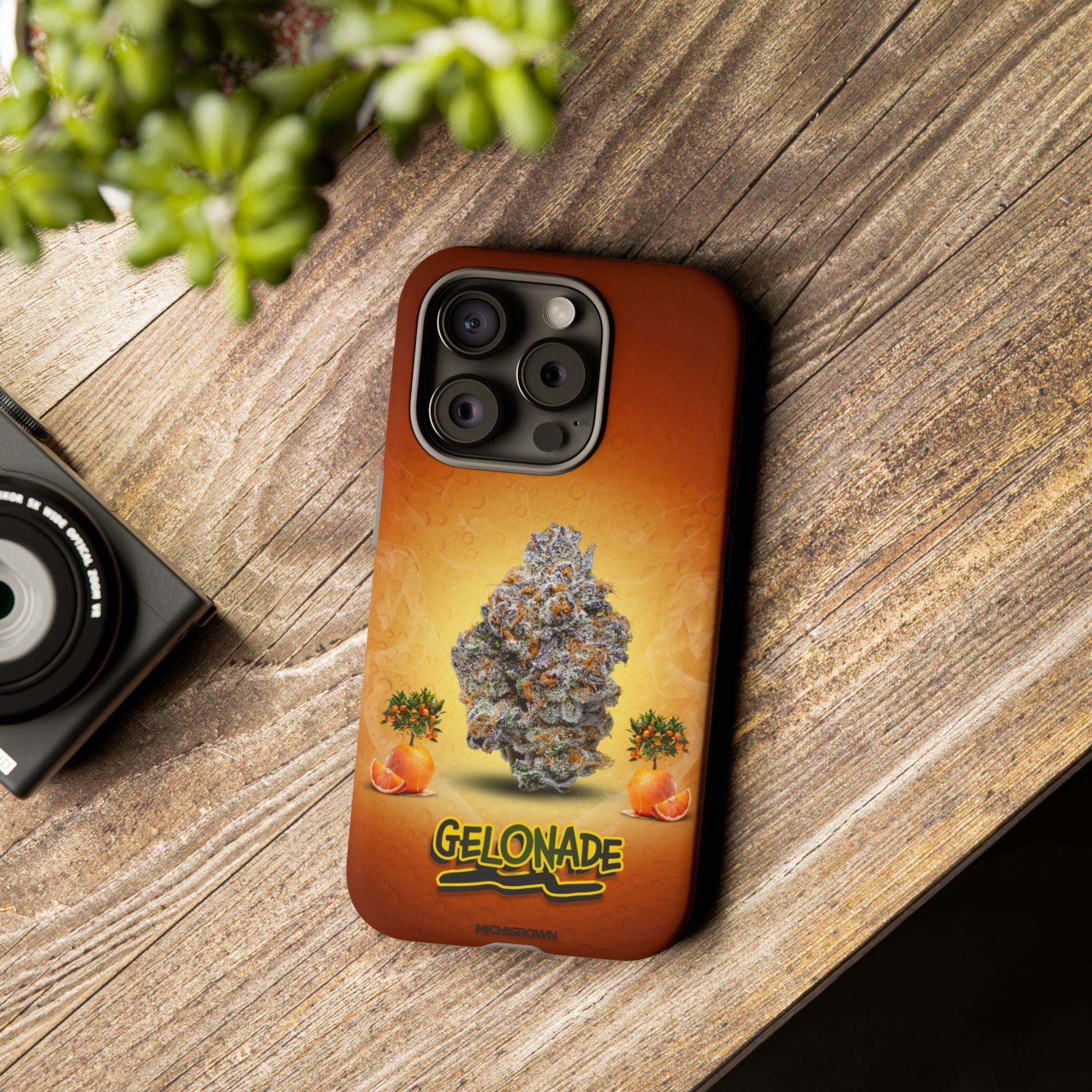 Phone case featuring cannabis bud and GELONADE logo on wooden surface.