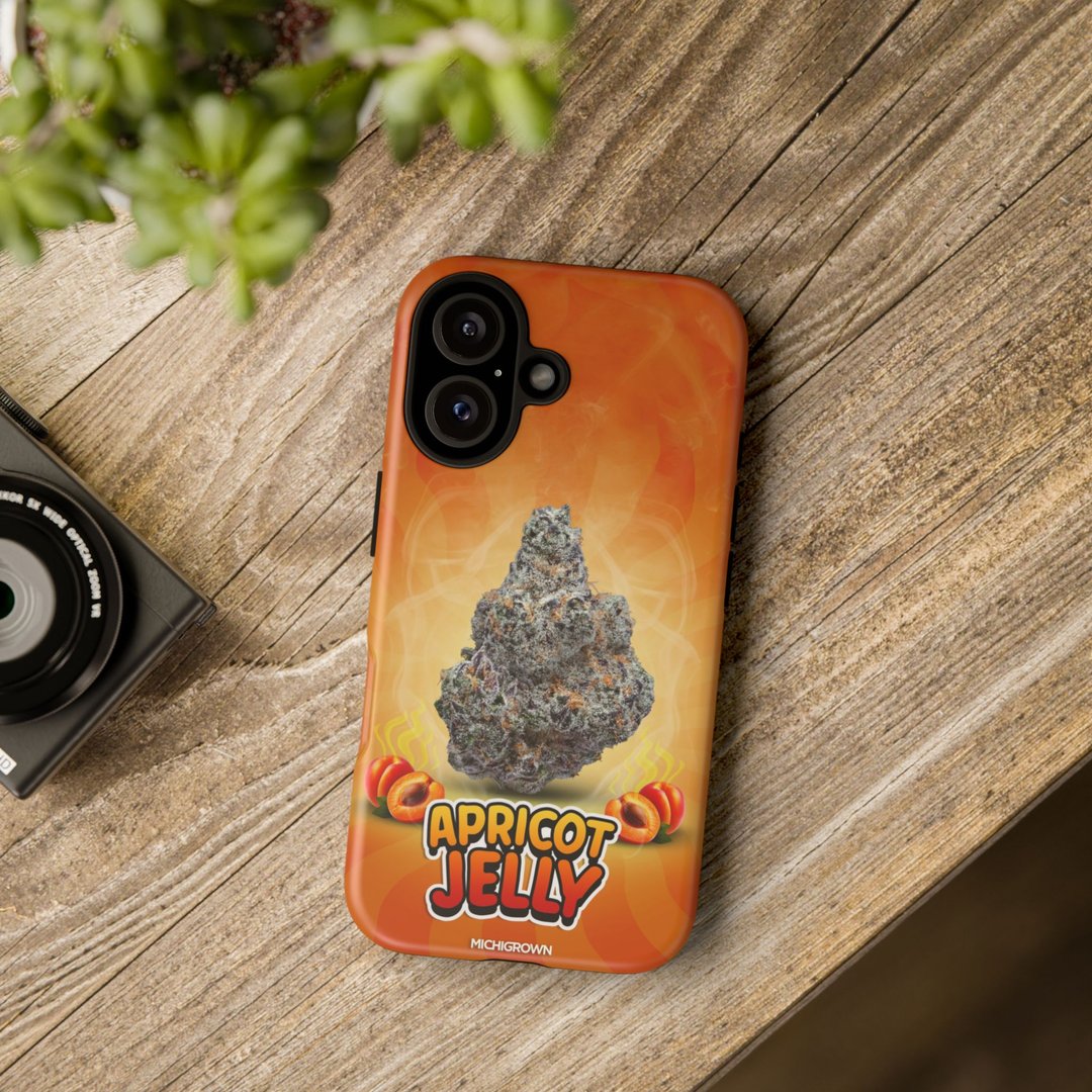 Phone case with apricot jelly design on a wooden surface.