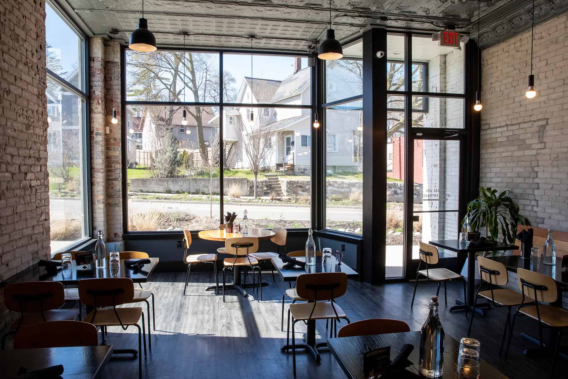 Cozy coffee shop with large windows and modern decor.