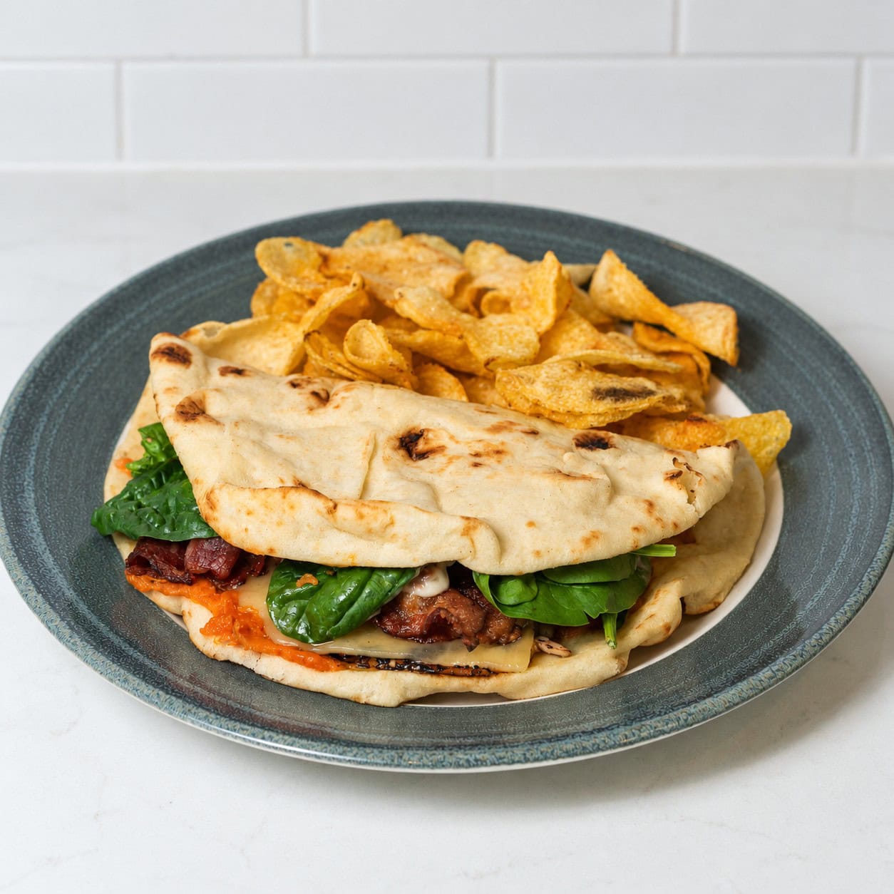 Salmon wrap with spinach and potatoes on a blue plate.