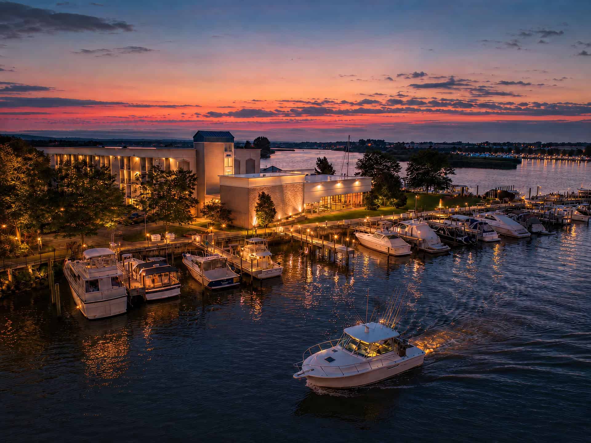 Boat dock with luxury yachts at sunset.
