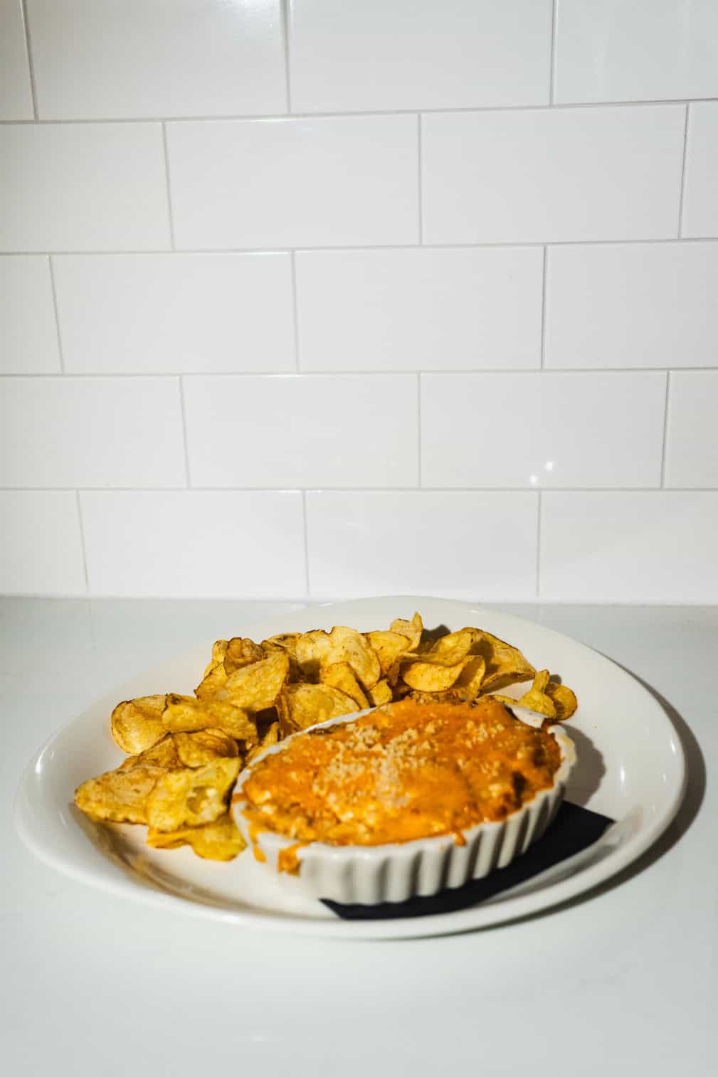 Baked chipotle chicken dip served with tortilla chips.