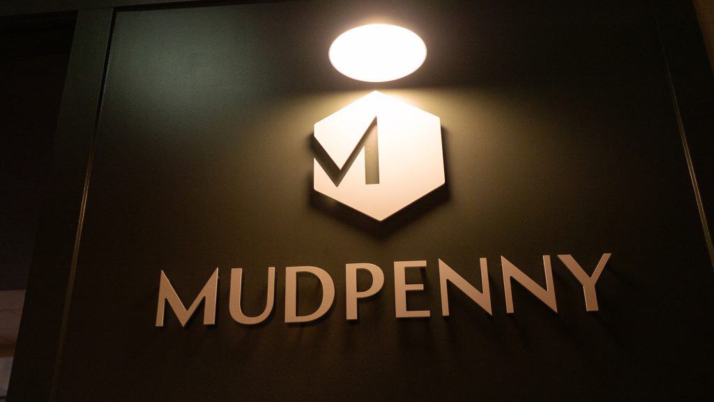 Mudpenny logo illuminated for private event space.