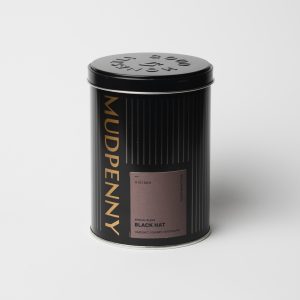 Mudpenny decaf coffee tin with black hat blend label.